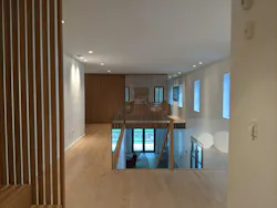 Slotted wood screens throughout the house serve as light accents and dividers but also conceal doors on the third floor. Slotted wood screens throughout the house serve as light accents and dividers but also conceal doors on the third floor.