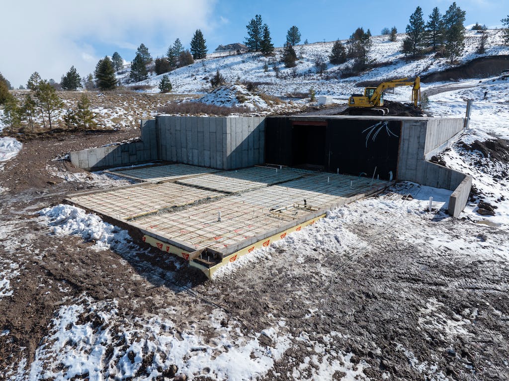 construction site in the snow with below-grade insulation