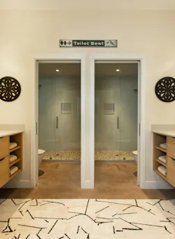 A side-by=side bathroom with double vanities. A side-by=side bathroom with double vanities.