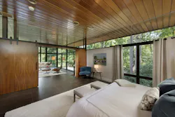 The primary bedroom features large partition walls that can be opened or closed depending on the homeowners' preference. The primary bedroom features large partition walls that can be opened or closed depending on the homeowners' preference.