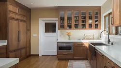 A fridge hidden behind wooden cabinetry A fridge hidden behind wooden cabinetry