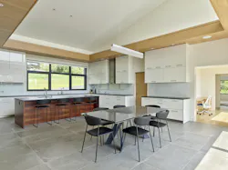 Montem Villam kitchen with white cabinets and wood detailing at the ceiling plane Montem Villam kitchen with white cabinets and wood detailing at the ceiling plane