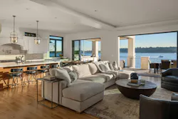 A living room with large windows and a balcony, showing an example of indoor-outdoor space A living room with large windows and a balcony, showing an example of indoor-outdoor space