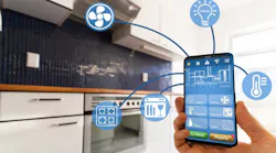 A luxury homeowner uses smart kitchen features on their phone A luxury homeowner uses smart kitchen features on their phone