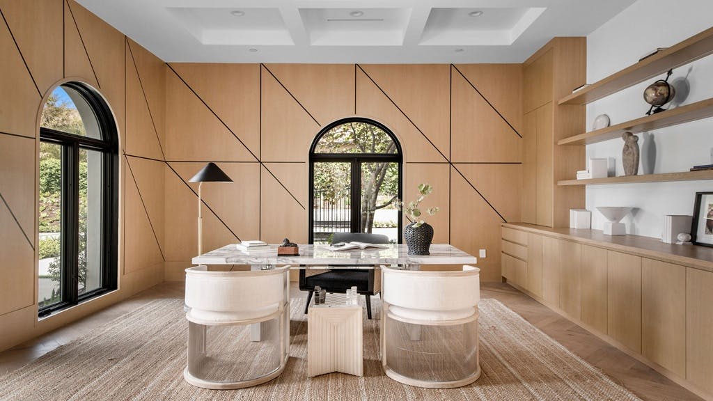 A wood-drenched interior with light wood flooring, walls, and cabinetry, reflecting the 'wood-drenching' trend