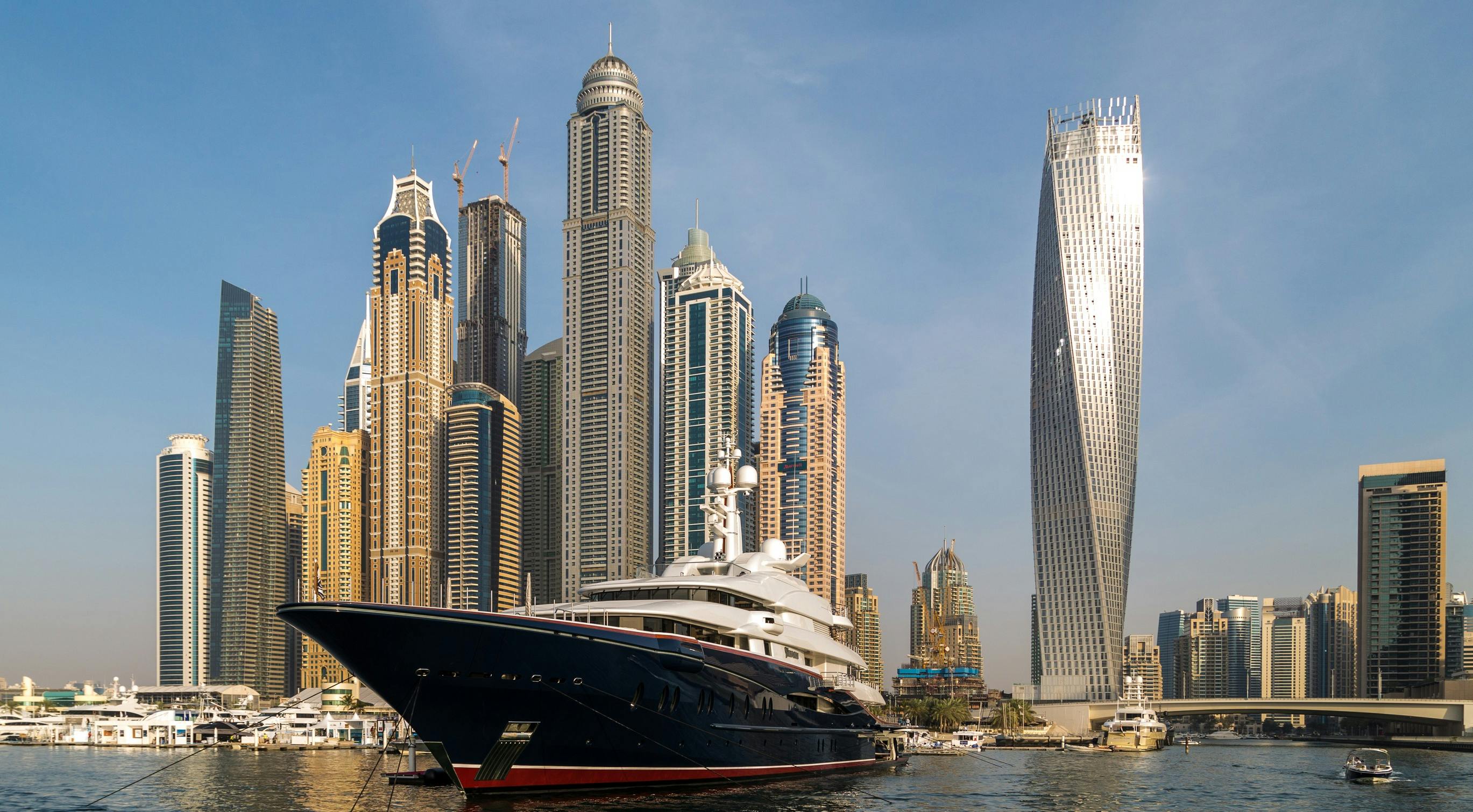 Skyline of Dubai with a luxury yacht | Custom Builder Wealth Report