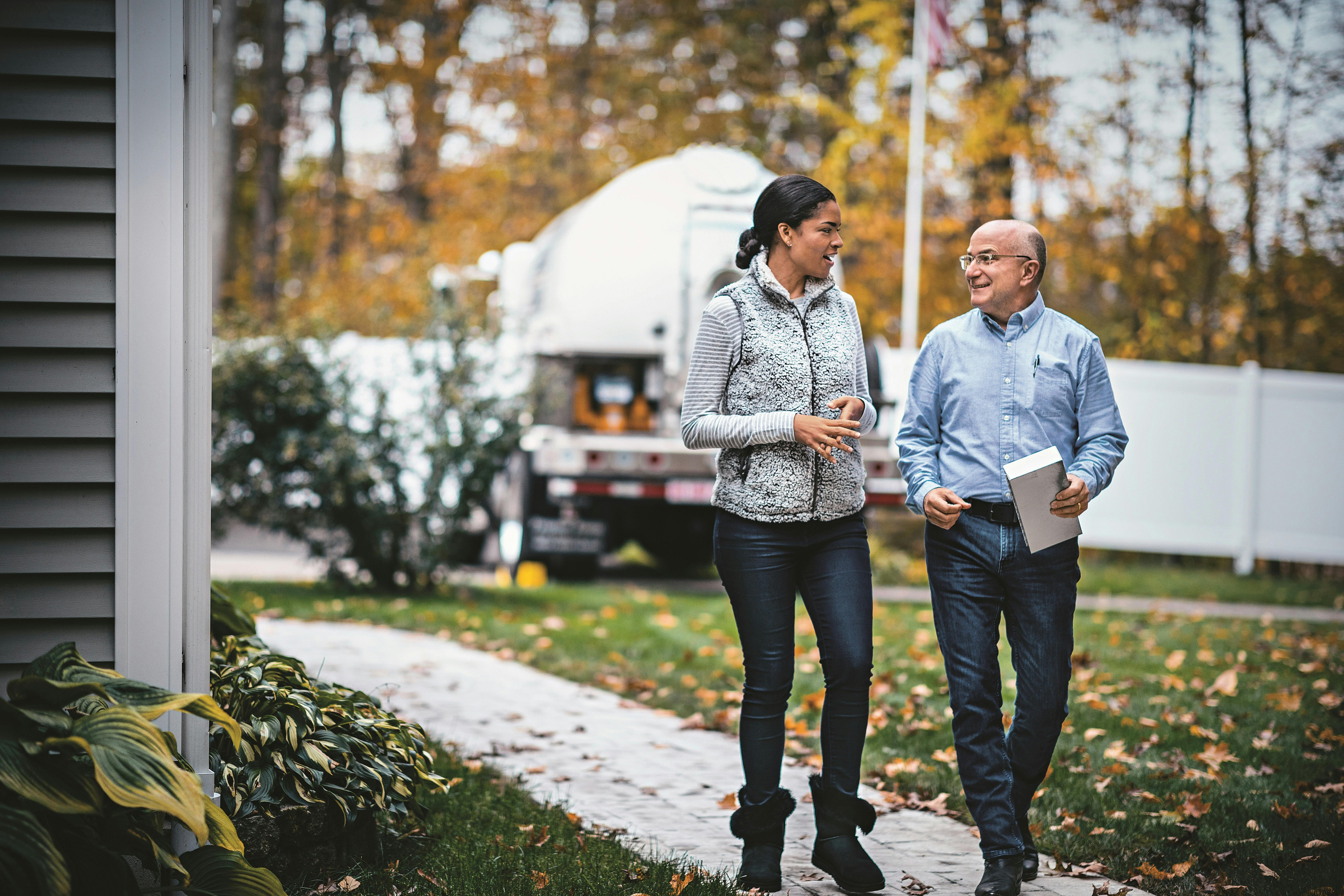 Homeowner walking with propane supplier | Custom Builder