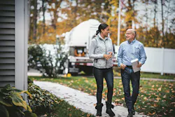 Homeowner walking with propane supplier | Custom Builder Homeowner walking with propane supplier | Custom Builder