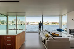 Main area of the home showing glass walls that overlook waterfront Main area of the home showing glass walls that overlook waterfront