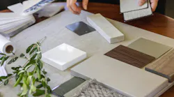 Designer laying out a sample board of selections for a client Designer laying out a sample board of selections for a client