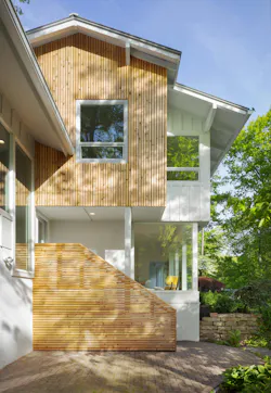 Once clad in dull reds and browns, the exterior was refreshed with white stucco for brightness; cedar siding conveys warmth. Once clad in dull reds and browns, the exterior was refreshed with white stucco for brightness; cedar siding conveys warmth.