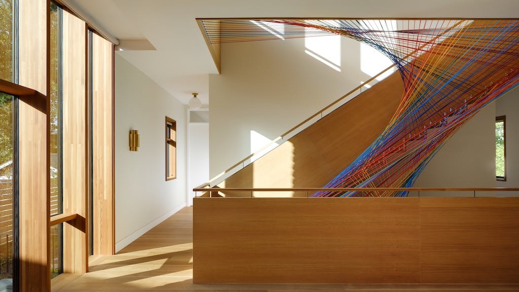 After adding a unique rainbow netting, this staircase became the centerpiece of this 8,500-square-foot custom home.