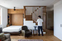 GIF Image of a person shifting the wooden lovers on a staircase that creates a solid wall to transform this living room into a guest room. GIF Image of a person shifting the wooden lovers on a staircase that creates a solid wall to transform this living room into a guest room.