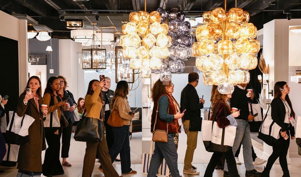 Designers walking through a showroom at the Dallas Market Center's Lightovation lighting event