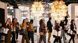Designers walking through a showroom at the Dallas Market Center's Lightovation lighting event Designers walking through a showroom at the Dallas Market Center's Lightovation lighting event