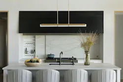 Adjacent to the great hall, this showpiece kitchen serves as an entertaining hub, concealing cooking tools behind sliding doors on either side of the range. Adjacent to the great hall, this showpiece kitchen serves as an entertaining hub, concealing cooking tools behind sliding doors on either side of the range.