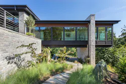 Fifty-foot steel I-beams were craned into place and threaded through a three-foot-thick stone wall, extending deep into the hillside to carry the load and hold the cantilever tight. Fifty-foot steel I-beams were craned into place and threaded through a three-foot-thick stone wall, extending deep into the hillside to carry the load and hold the cantilever tight.