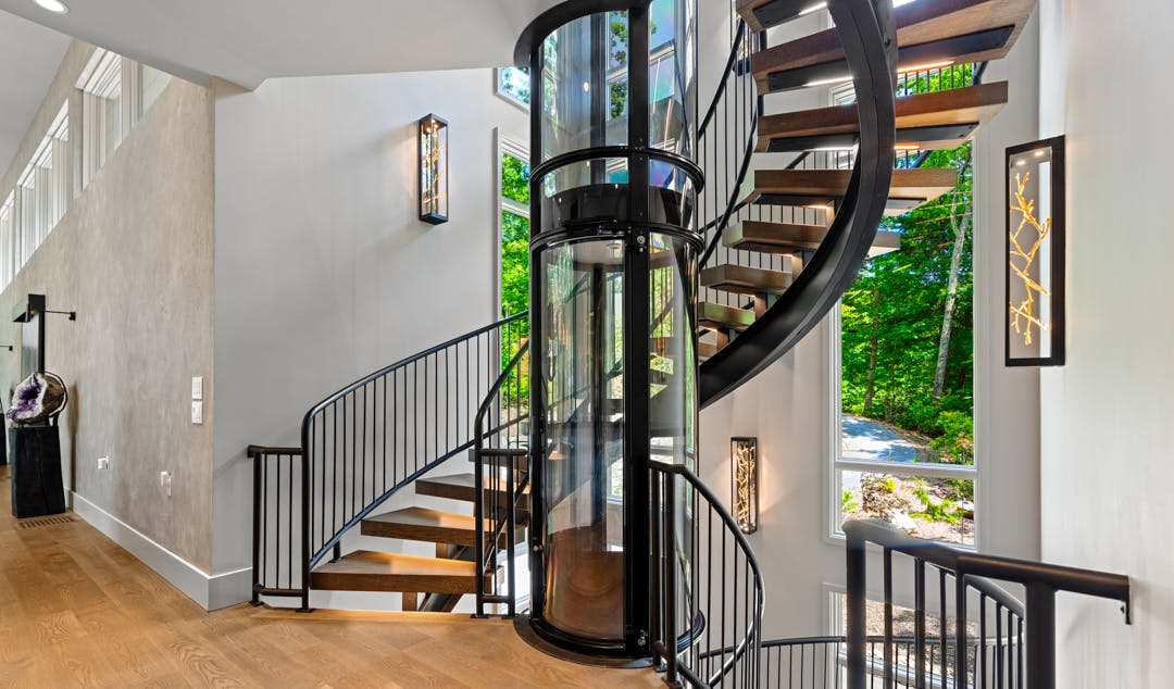 Wrapped around a glass elevator, this staircase posed a unique challenge: create an open, visually interesting design while remaining structurally sound.