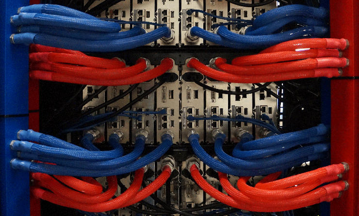 The rear view of a rack of servers using the LiquidCool immersion system. Blue lines bring dielectric coolant to the server to cool components, while the red lines return the fluid to a heat exchanger. (Photo: LiquidCool Solutions)