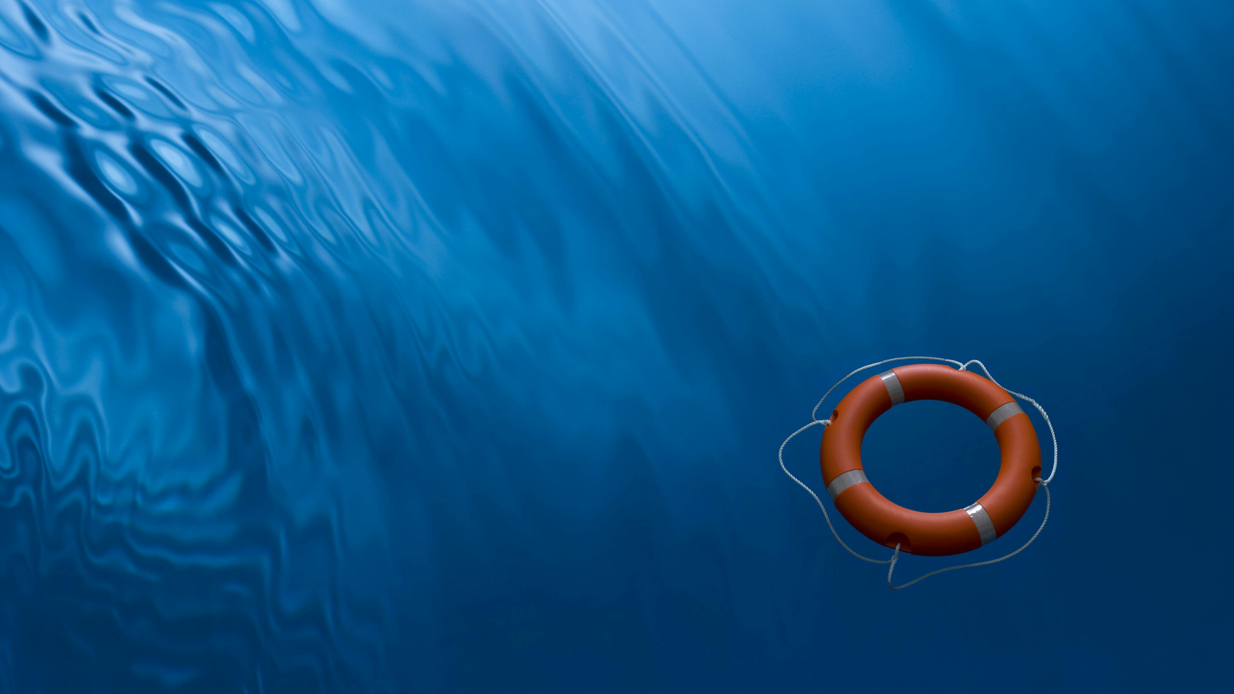 A lifebuoy ring on a blue water background