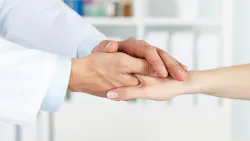 Friendly dentist's hands holding female patient's hand for encouragement and empathy. Friendly dentist's hands holding female patient's hand for encouragement and empathy.