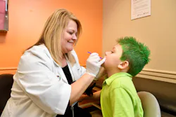 Dawn Brewer, APRN, applies fluoride varnish at a wellness check. Dawn Brewer, APRN, applies fluoride varnish at a wellness check.