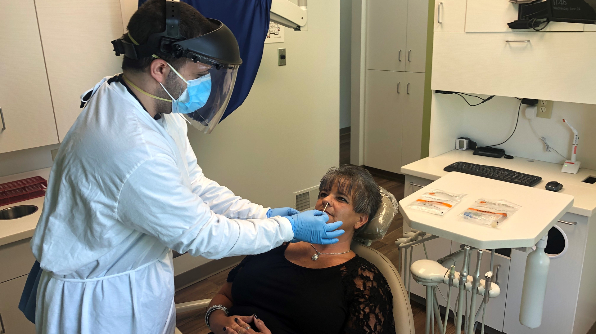 Radwan Almomani, DMD, administers a COVID-19 test to a patient at Refresh Dental in New Castle, Pennsylvania.