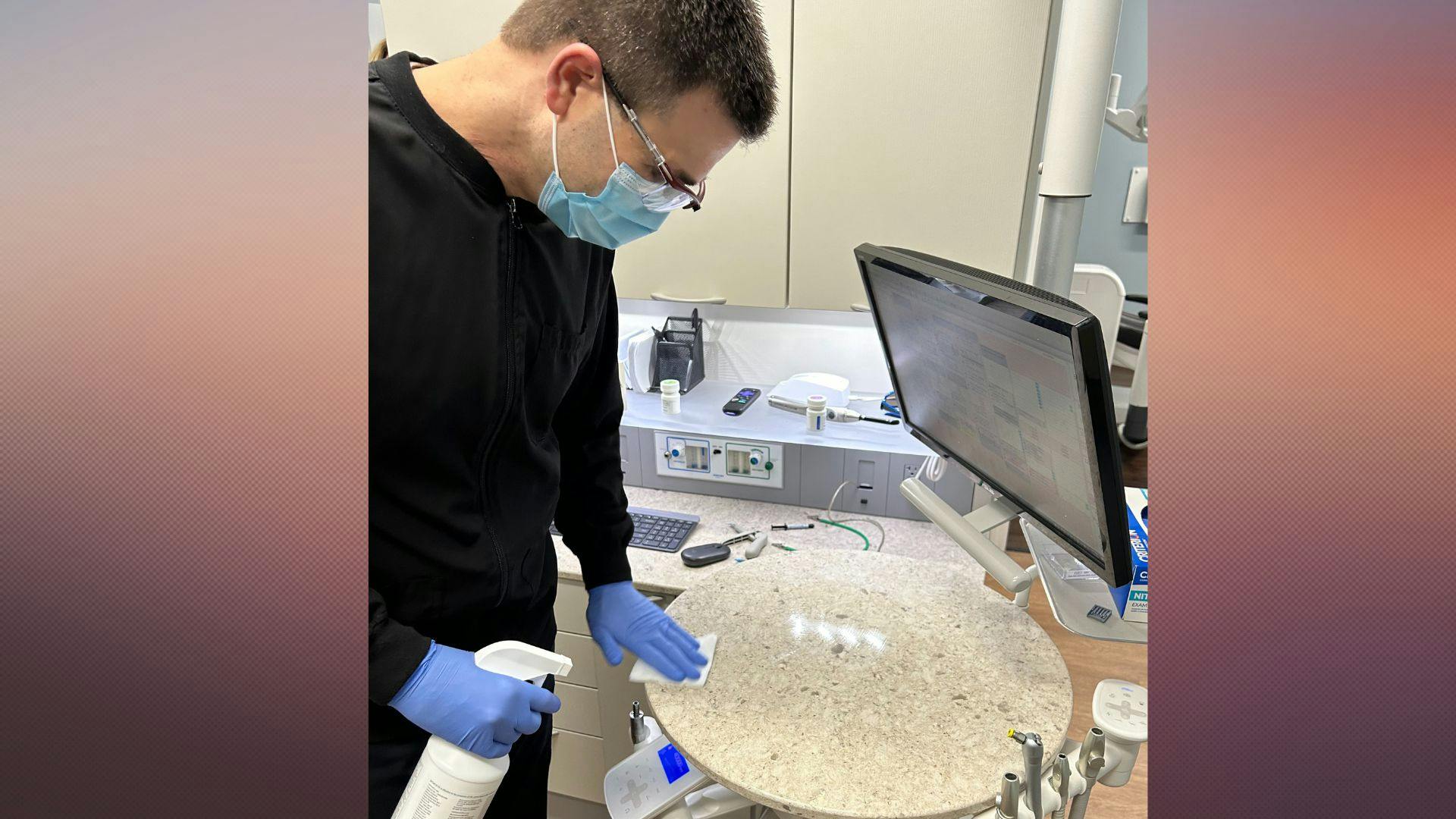 Eric Hurtte, DMD, assists the infection control coordinator in his practice by disinfecting some equipment.