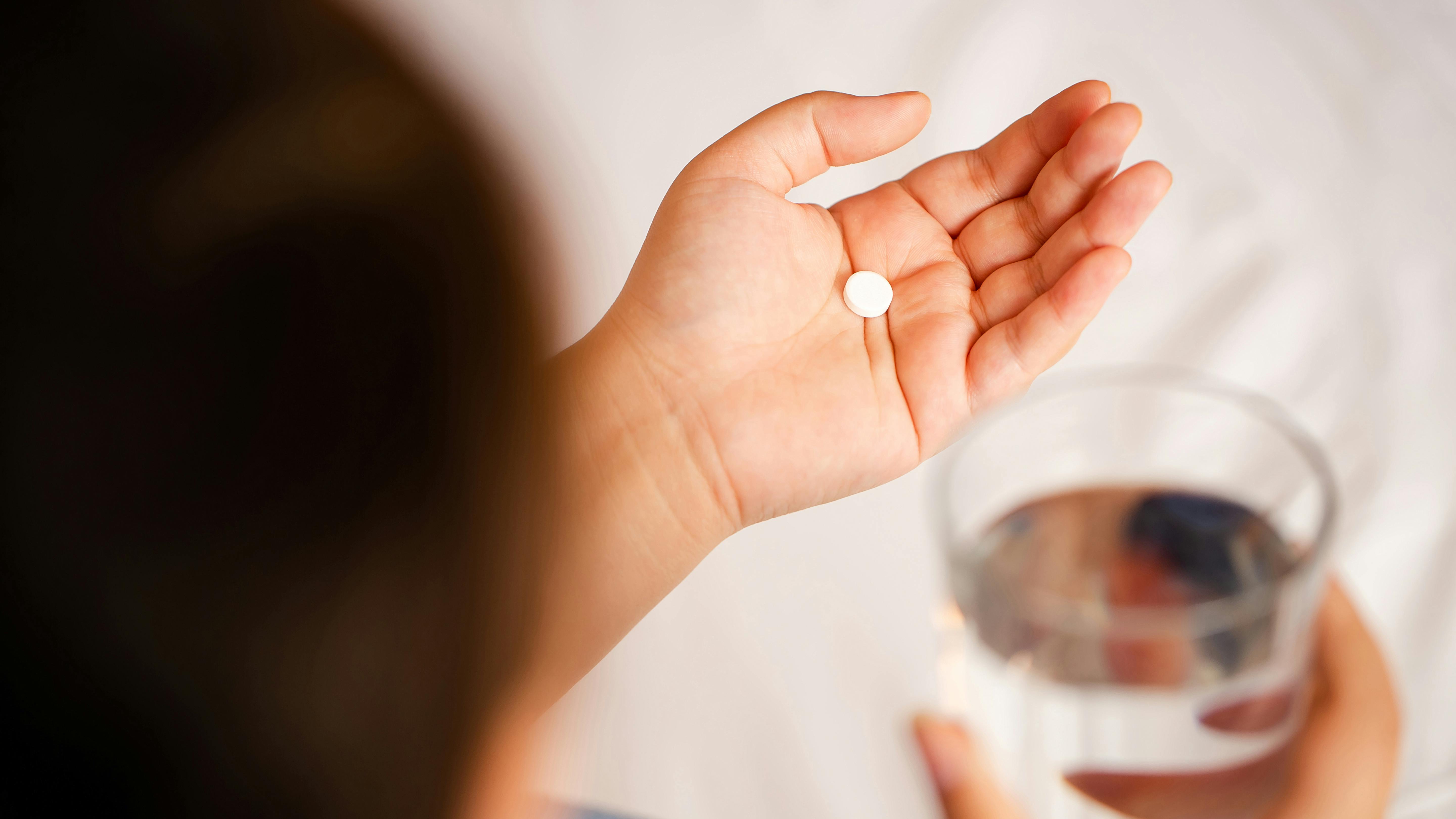 Person holding a pill