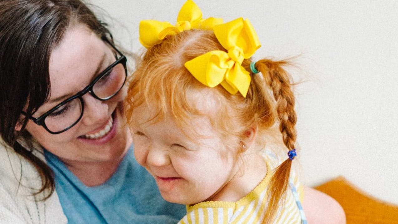 mom holding a little girl