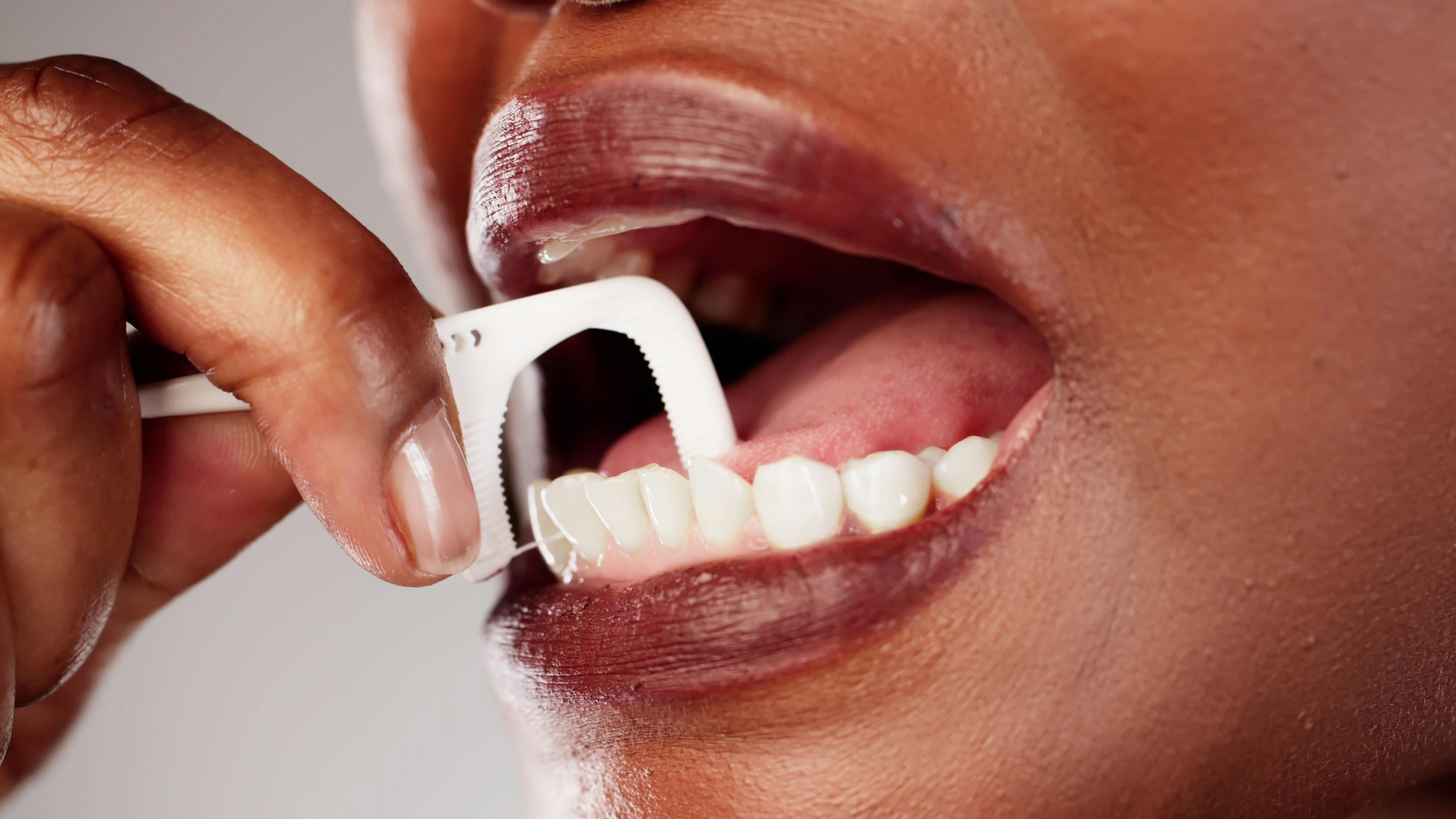 Woman using dental pick floss