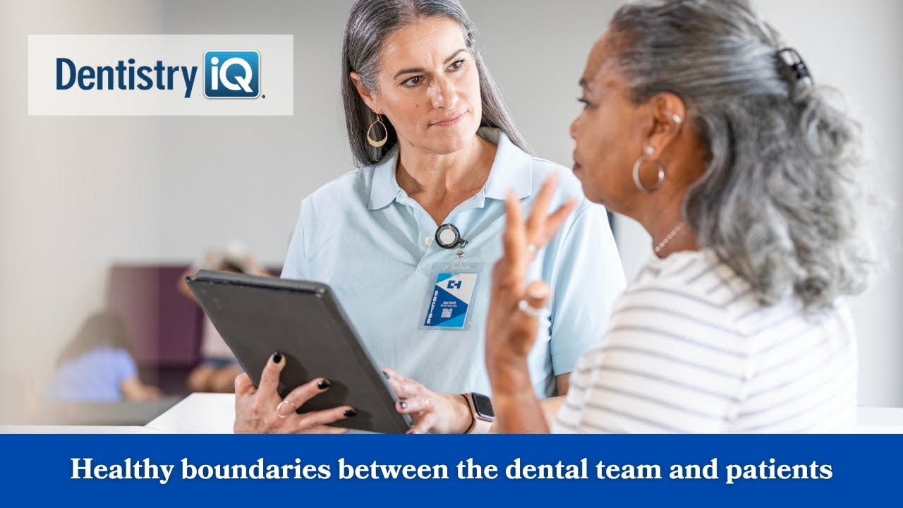 a dental team member talking to a patient