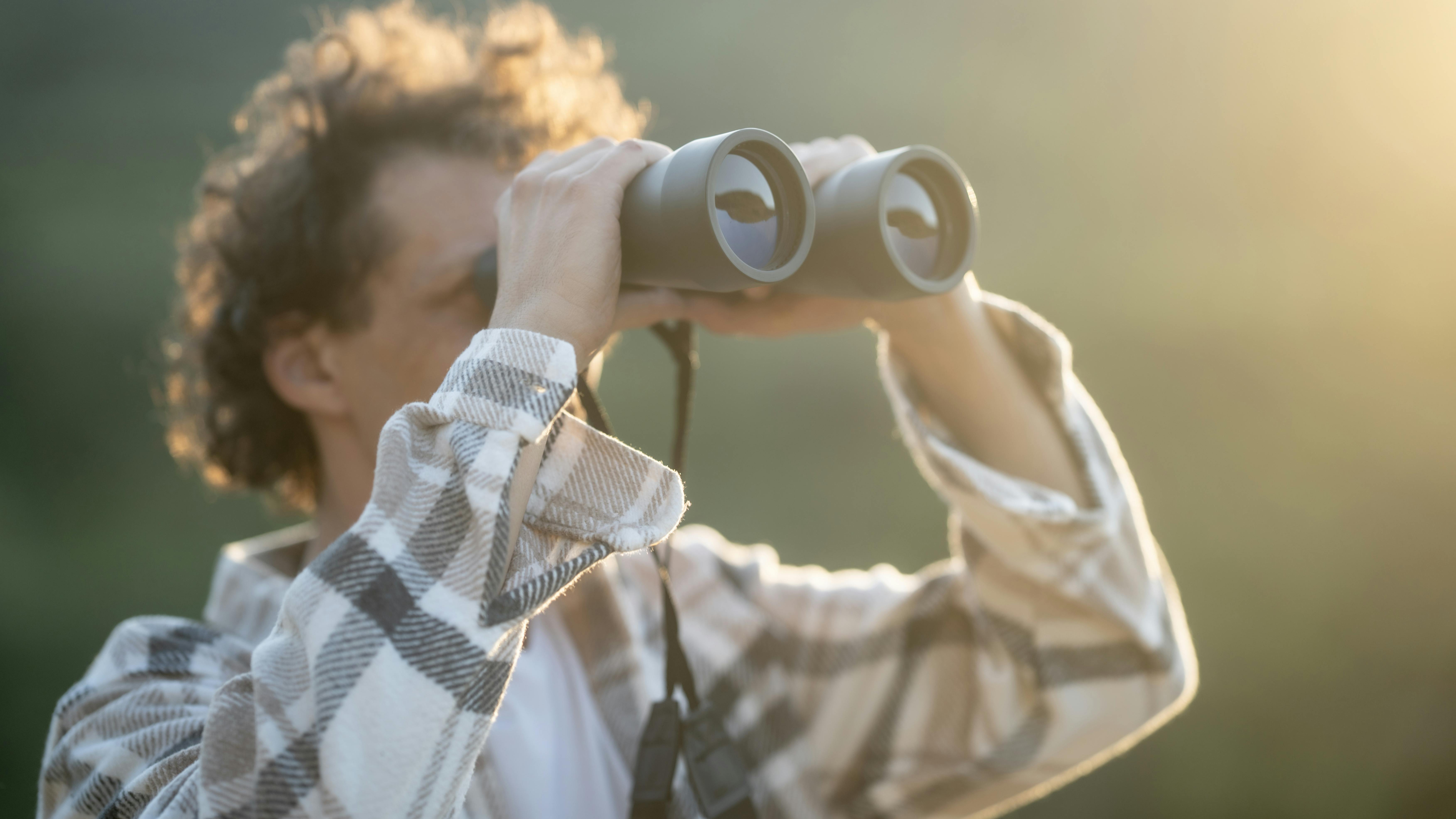 person looking through binoculars
