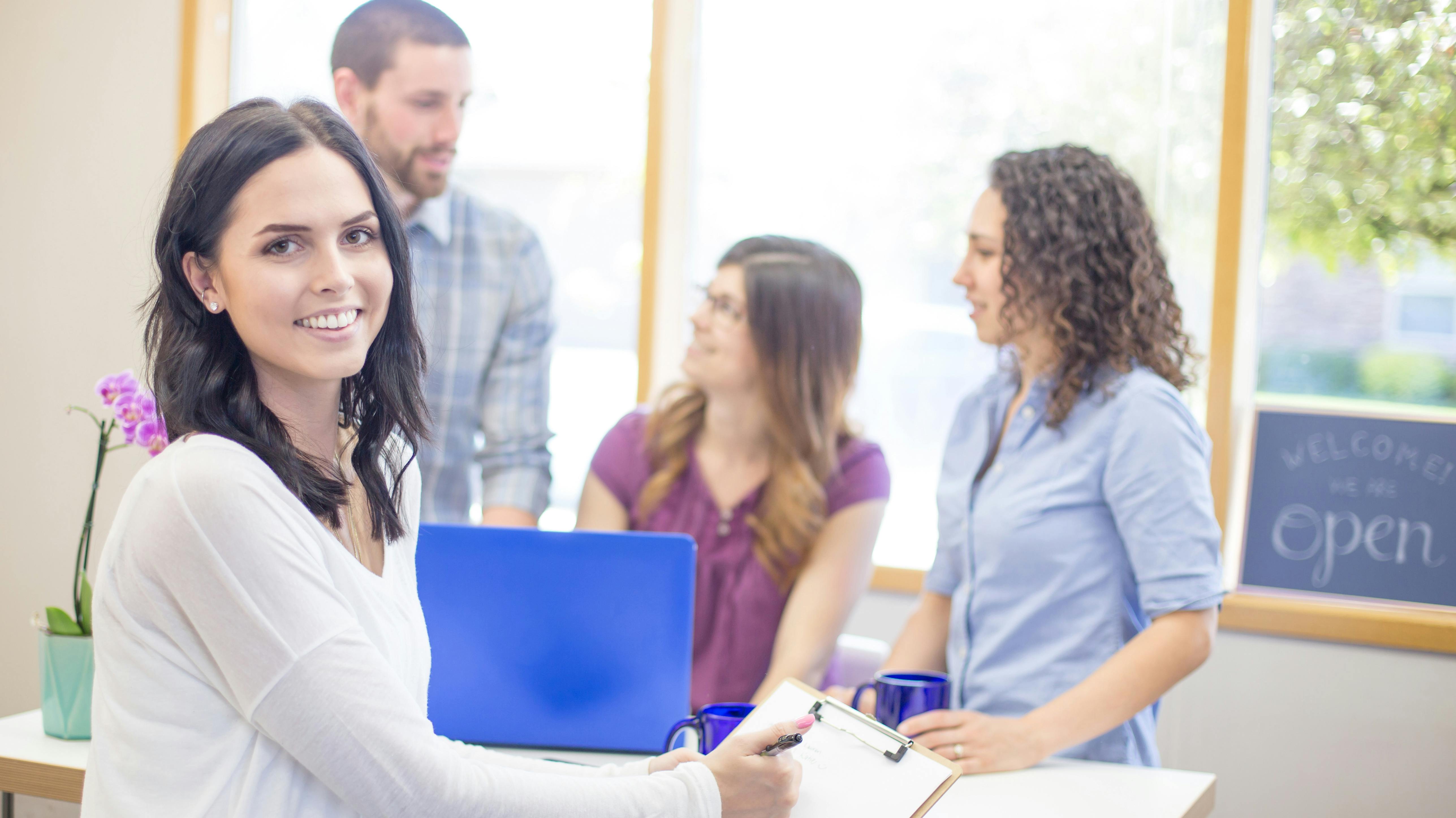 dental staff members meeting together at the front desk