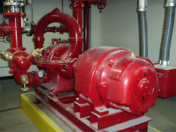 Red fire pump motor and piping system in equipment room Red fire pump motor and piping system in equipment room