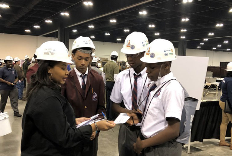 IEC coordinator Delast Muhammad with students