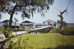 Photo 1. The boat dock on the far right is where the accident occurred. The wiring to the dock is routed on the opposite side of the walkway. Photo 1. The boat dock on the far right is where the accident occurred. The wiring to the dock is routed on the opposite side of the walkway.