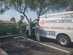 A masked employee of Allegiant Electric LLC, Las Vegas, gloves up before heading to a job site in a company vehicle. A masked employee of Allegiant Electric LLC, Las Vegas, gloves up before heading to a job site in a company vehicle.