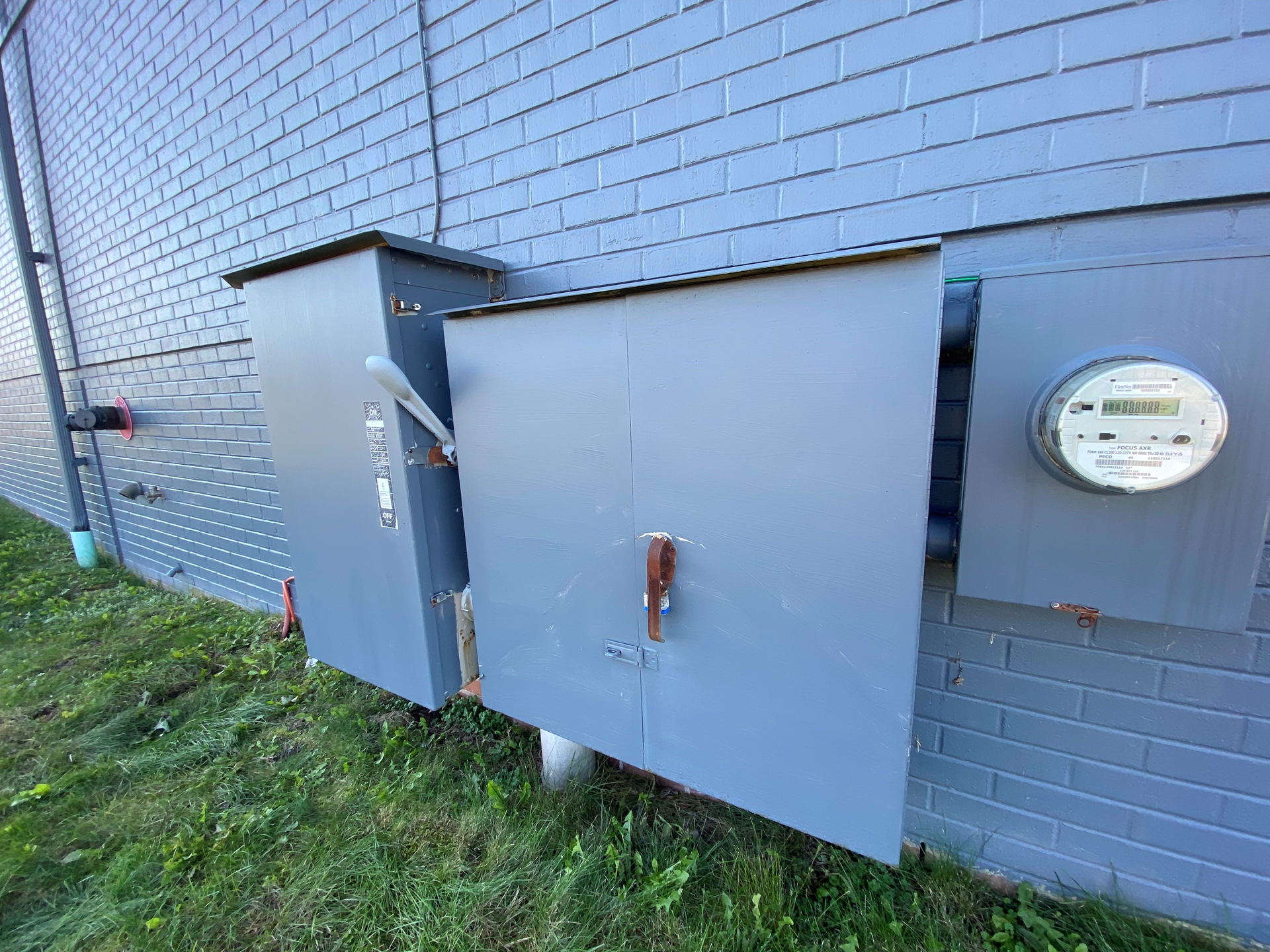 Main electrical service equipment and utility meter on the side of a commercial building