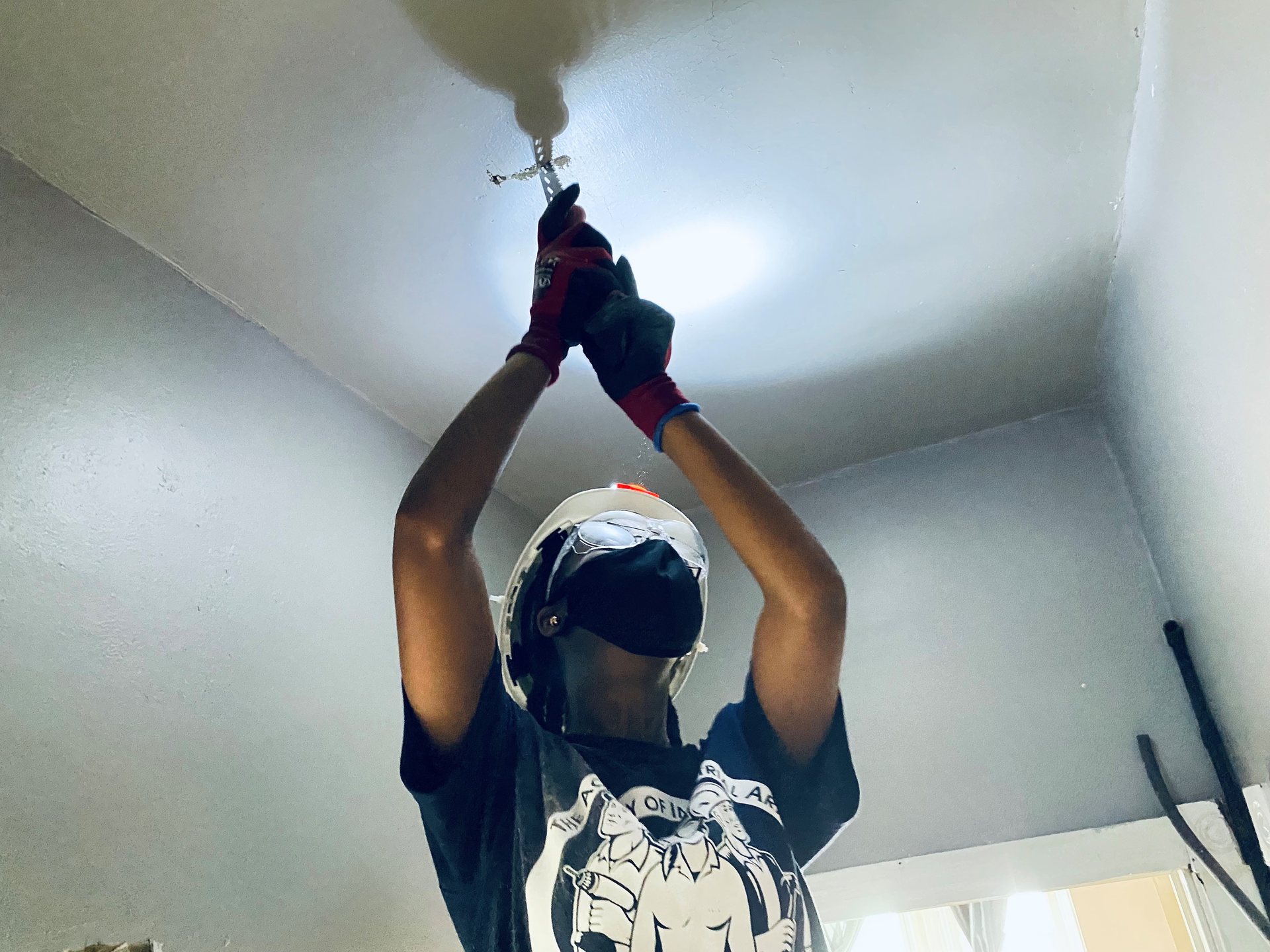 A female student at The Academy of Industrial Arts works on an electrical job.