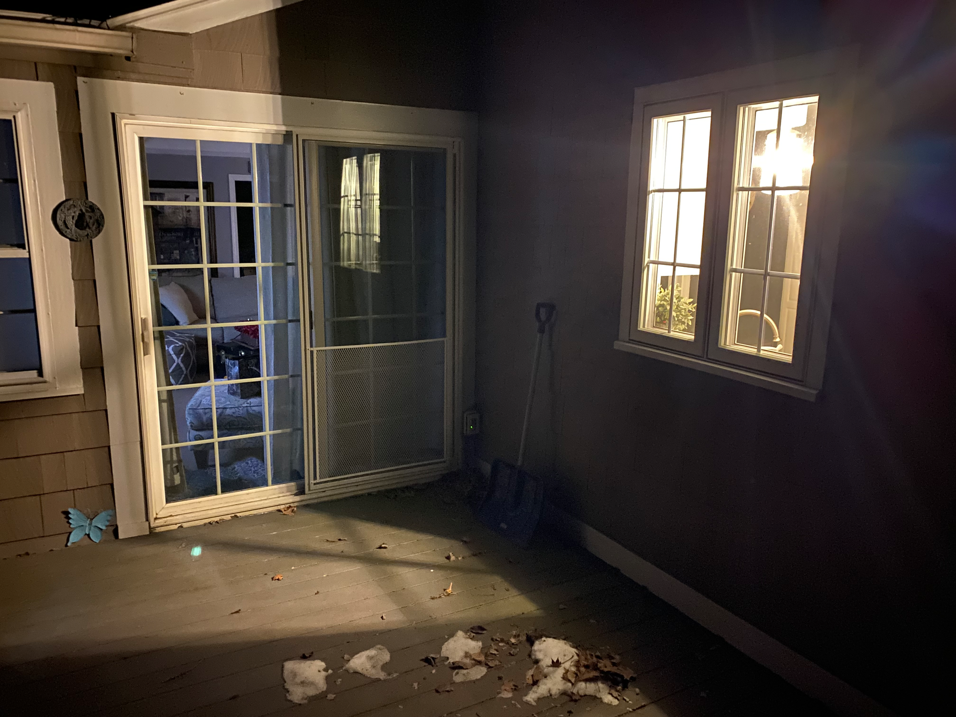 Photo. This luminaire shines light through the kitchen window and provides plenty of illumination on the exterior side of the sliding door.