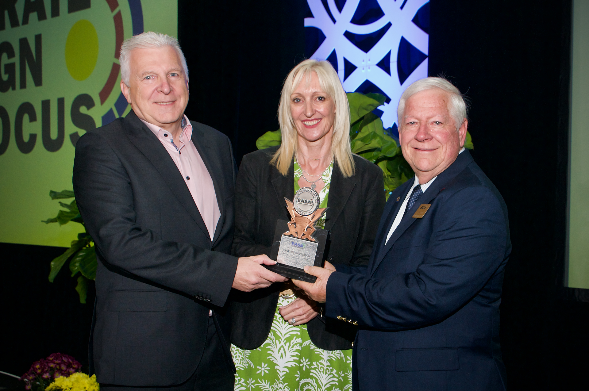 Past EASA Chairman Jerry Gray (right) presents EASA's 2022 Exceptional Achievement Service Award to David and Carol Griffin