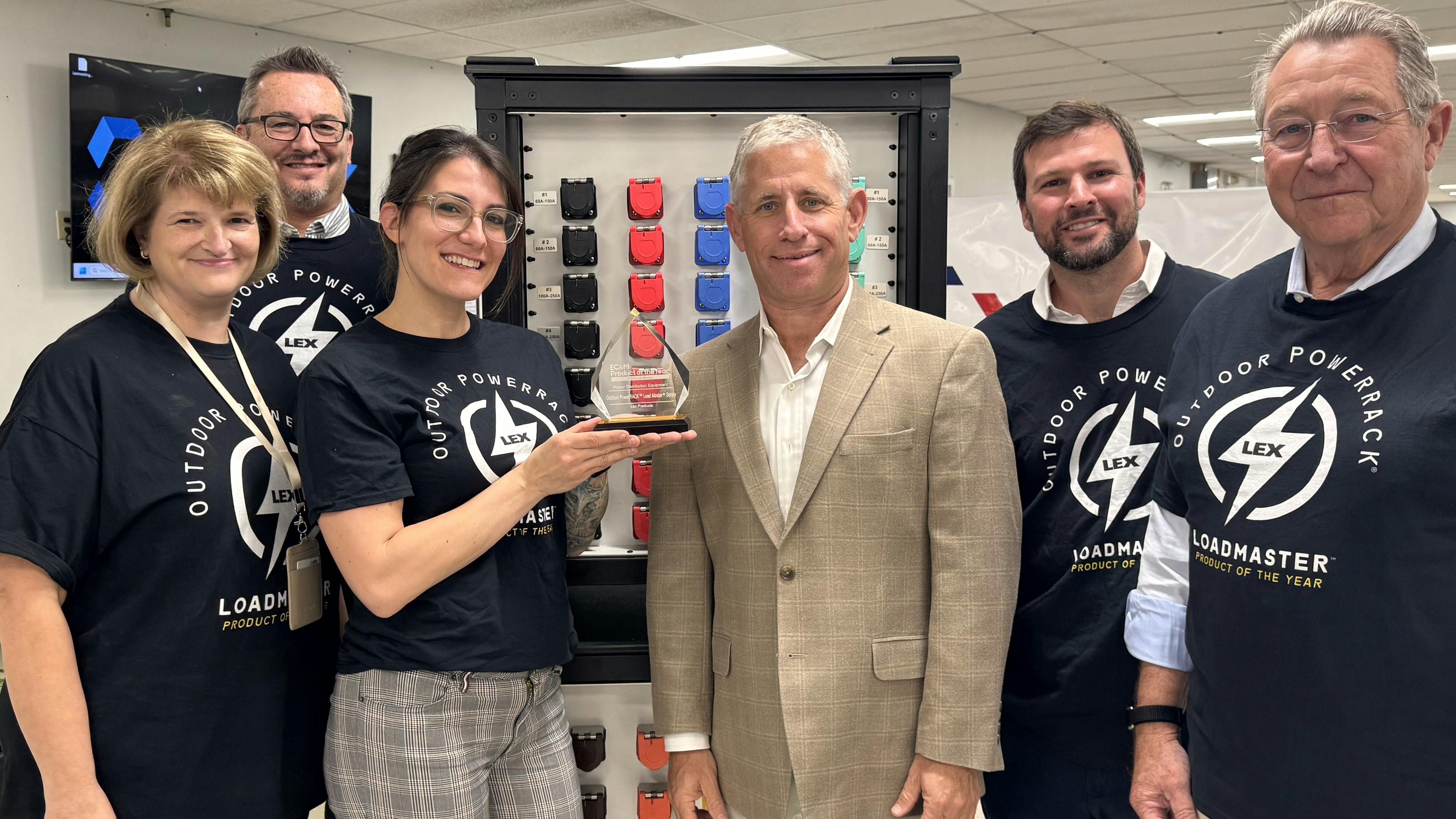 The photo shows (from left to right): Laurie Ely, chief financial officer; David Giroux, chief revenue officer; Rebecca Lore, industrial product manager; David Sevin, EC&M sales manager; Travis Fuller, vice president, engineering & analytics; and Jim Binch, chief executive officer with the trophy. As you can see, the group is donning sharp new custom-made t-shirts in celebration of this honor.