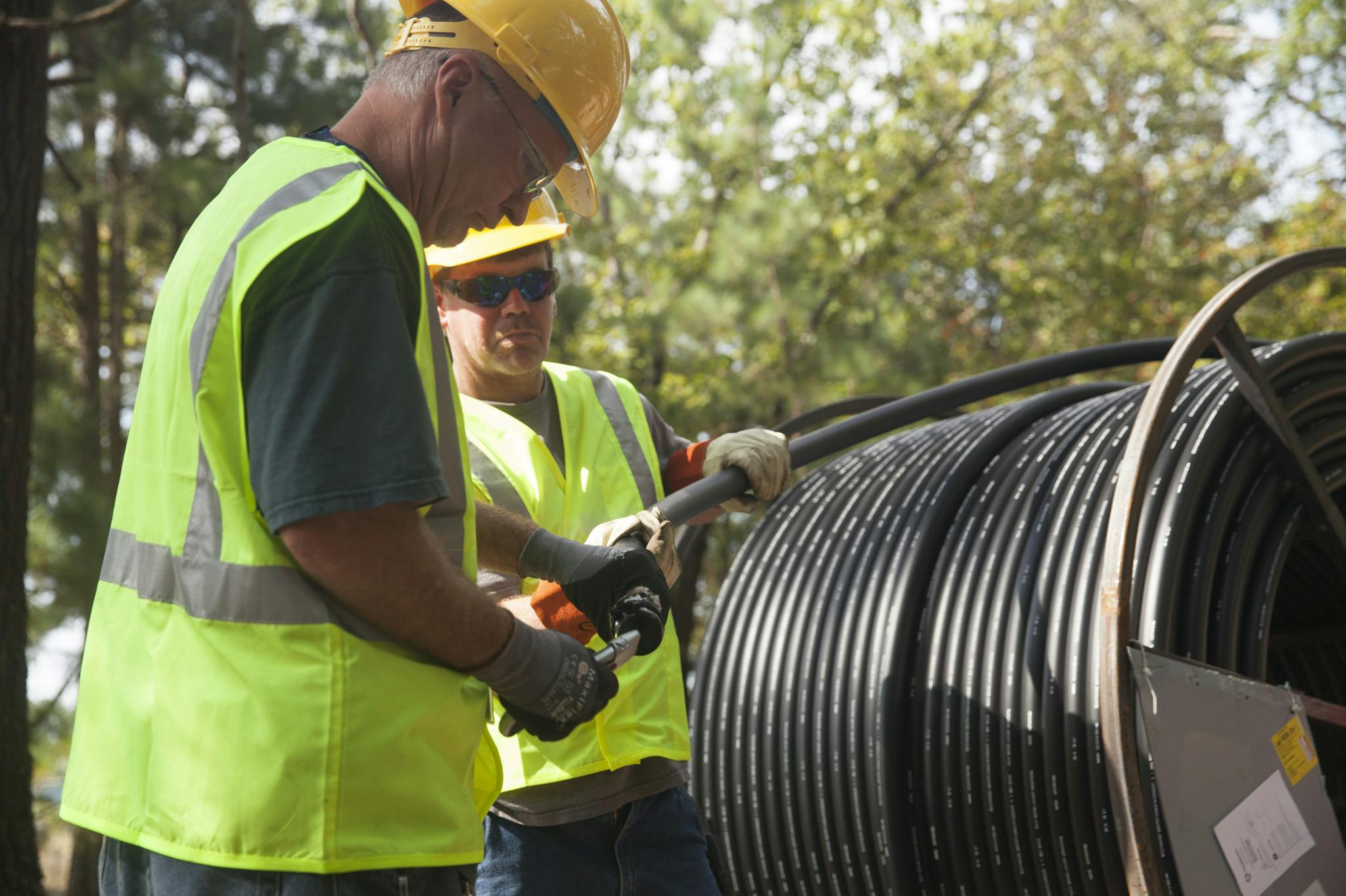 Two installers work with cable-in-conduit (CIC) on a job site