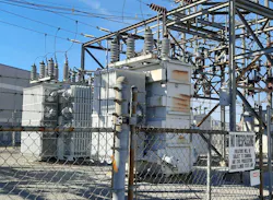 Photo 1. Oil-filled transformers equipped with insulator bushings (top), radiator fins, and cooling fans. Photo 1. Oil-filled transformers equipped with insulator bushings (top), radiator fins, and cooling fans.