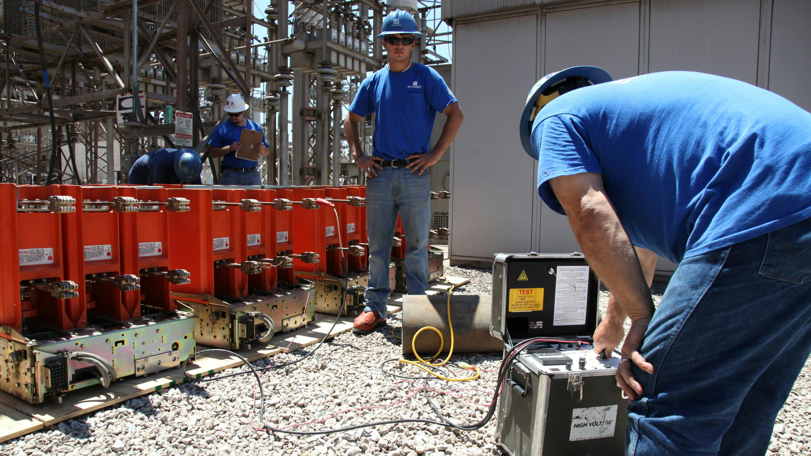 Photo 1. These workers are testing a medium-voltage circuit breaker. How equipment has been cared for is part of the condition of maintenance analysis.