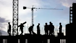 silhouette of construction workers working on scaffolding silhouette of construction workers working on scaffolding
