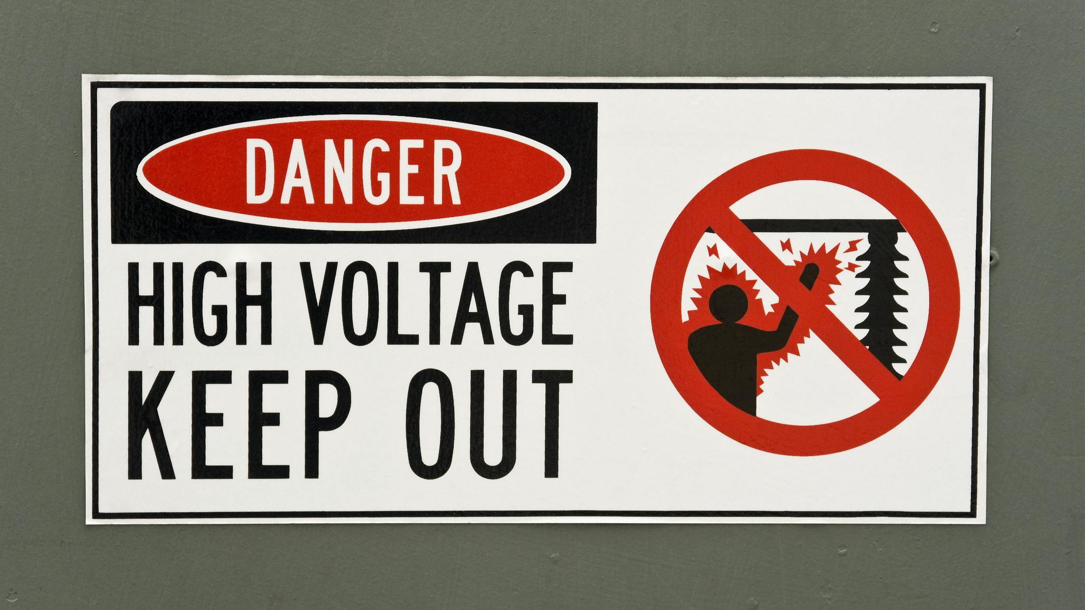 High Voltage Danger Sign Painted on the Metal Surface of a Transformer
