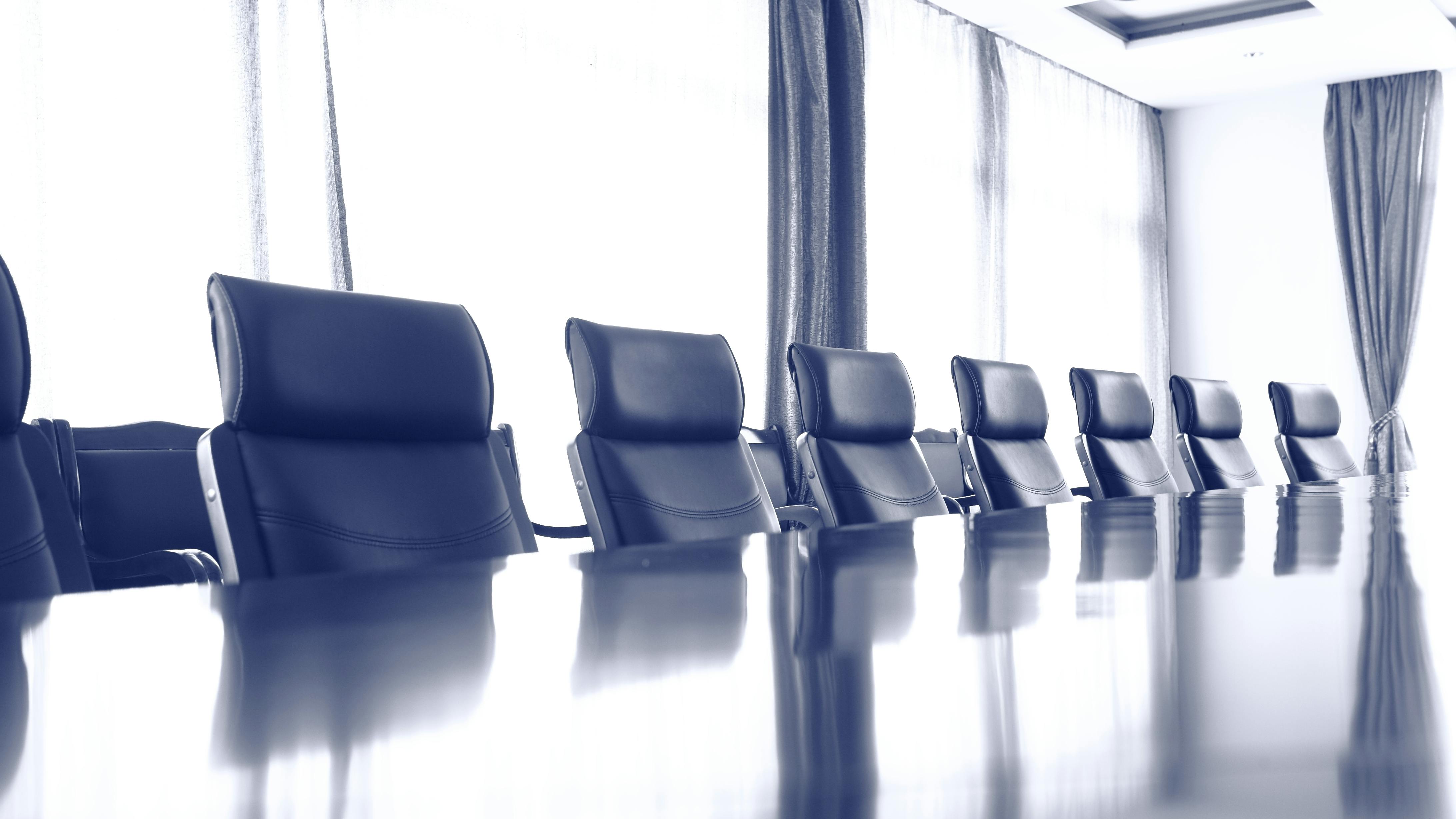 row of meeting room chairs at a table