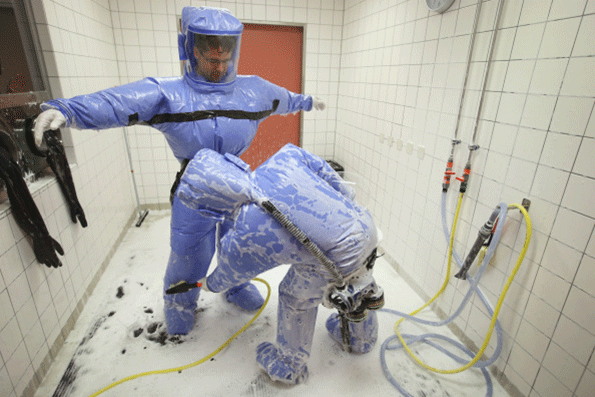 A doctor for tropical medicine and a nurse demonstrate the decontamination procedure as part of ebola treatment at Station 59 at Charite hospital on August 11 2014 in Berlin Germany The specialized quarantine unit at Station 59 is among a handful of facilities in Germany nationwide that are capable of handling ebola cases Photo by Sean GallupGetty Images